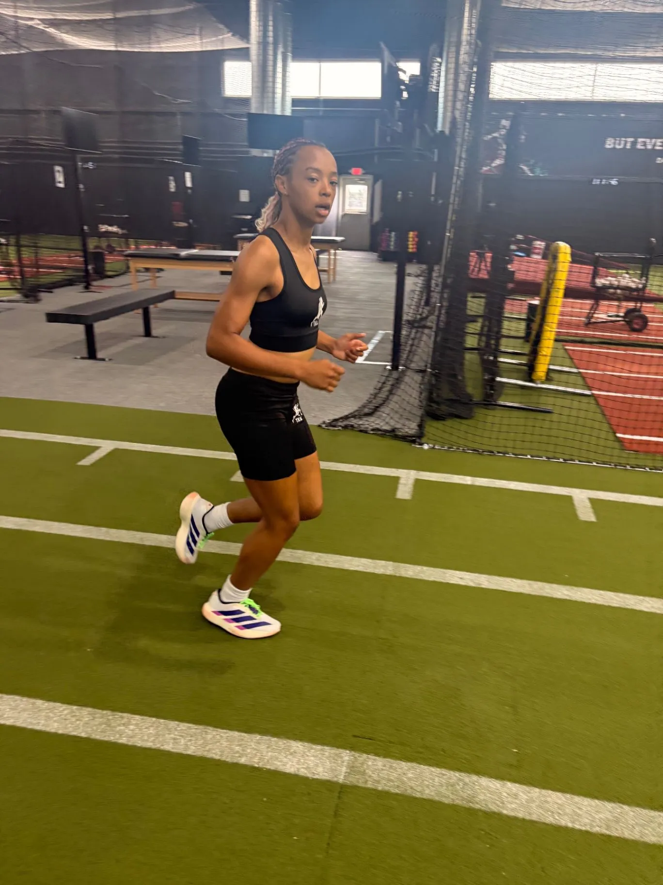 Nailah Belcher running through an indoor sprint session