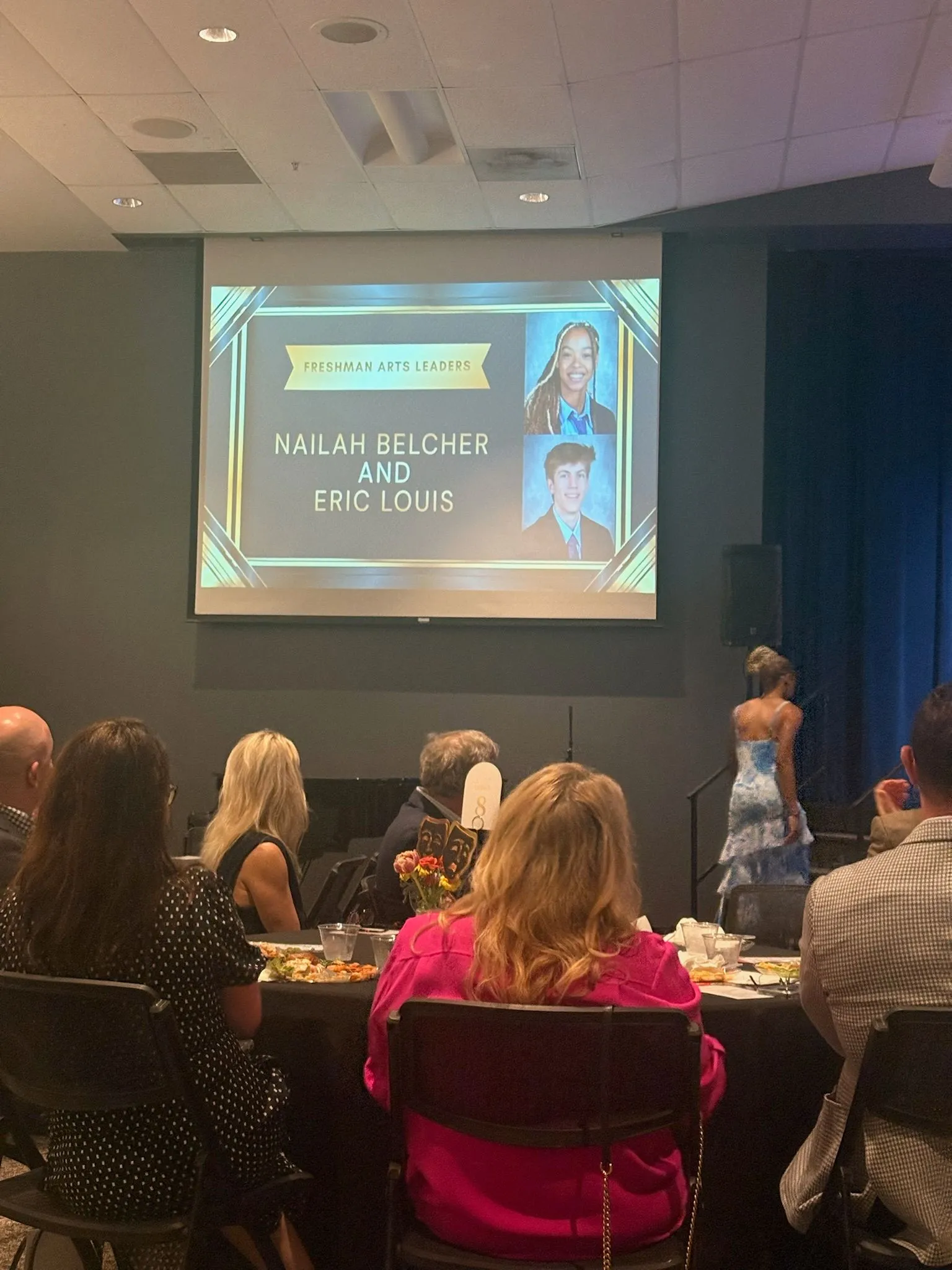 Presentation slide recognizing Nailah Belcher as a Freshman Arts Leader alongside Eric Louis